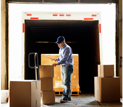 Image of person measuring a shipment on loading dock
