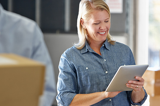Small business woman shipping freight from tablet