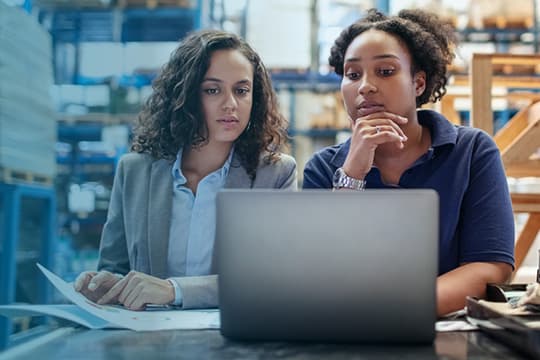 Two women looking at a computer